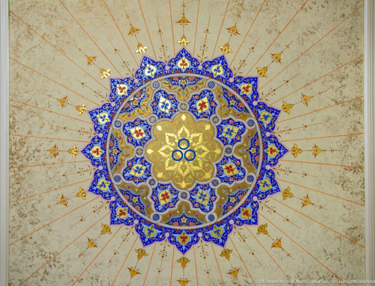 Circular eight-pointed ornament centered on pale ceiling.