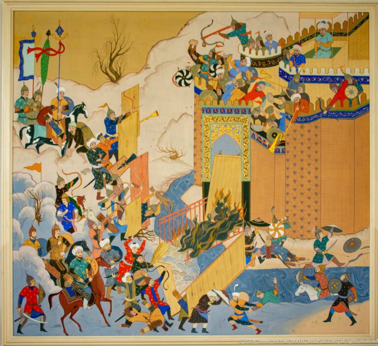 Soldiers attack walls with ladders while fire burns at a gate.