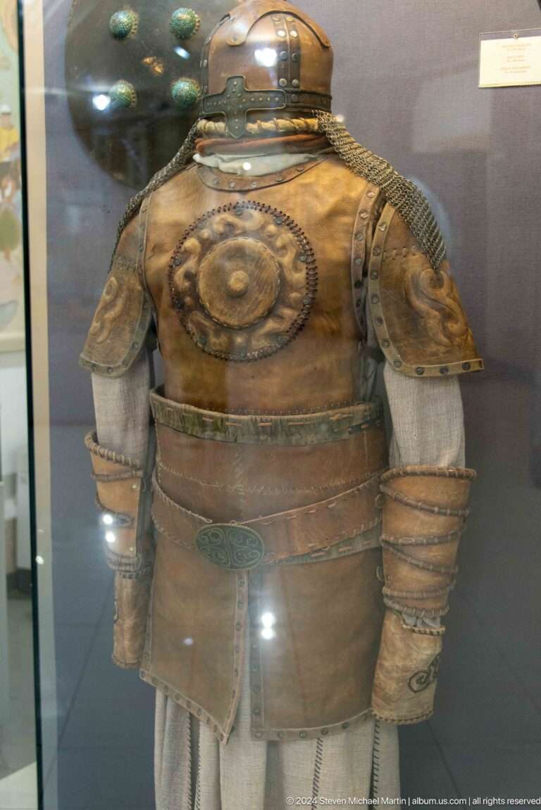 Brown armored torso displayed behind glass.