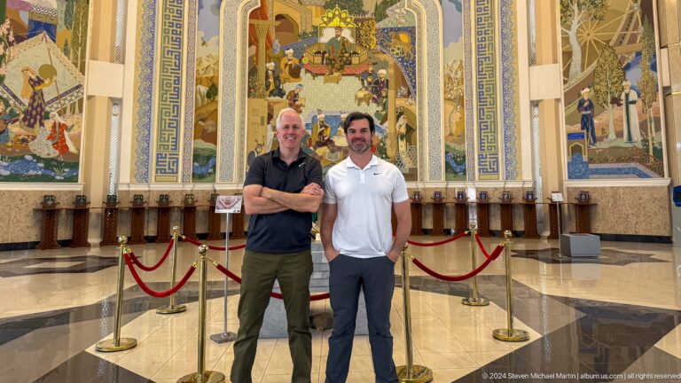 Two men standing shoulder to shoulder with folded arms.