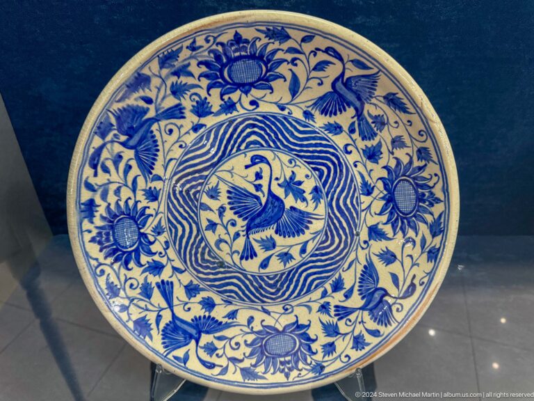 Round dish with bird medallion and floral border.