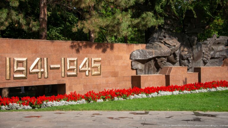 Stone memorial wall in Almaty with 1941–1945 engraved and a relief figure commemorating the Second World War.
