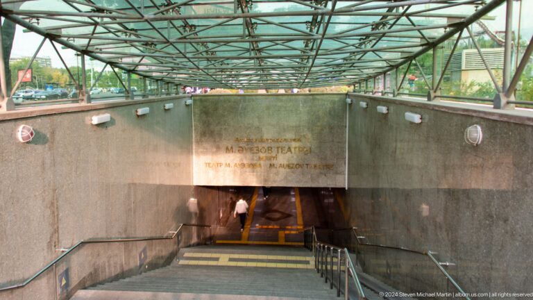 Covered entrance structure leading down to an underground Almaty Metro station.