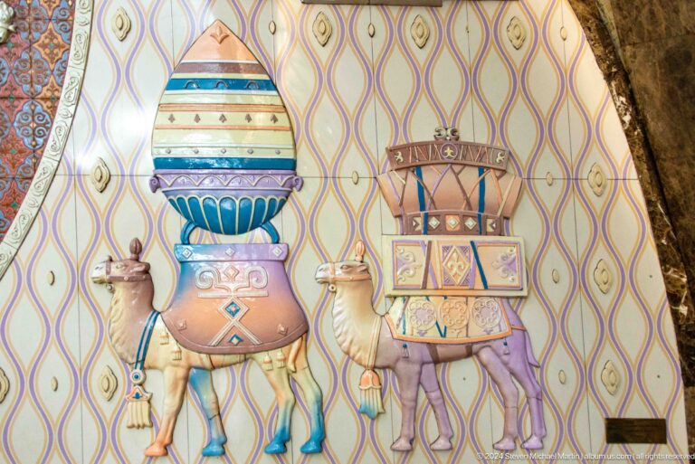 Kazakh mural featuring stylized pots and household objects arranged decoratively on a wall.