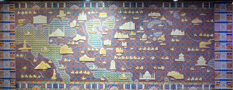 Large Kazakh tapestry showing yurts and pastoral scenes, photographed in Almaty, Kazakhstan.