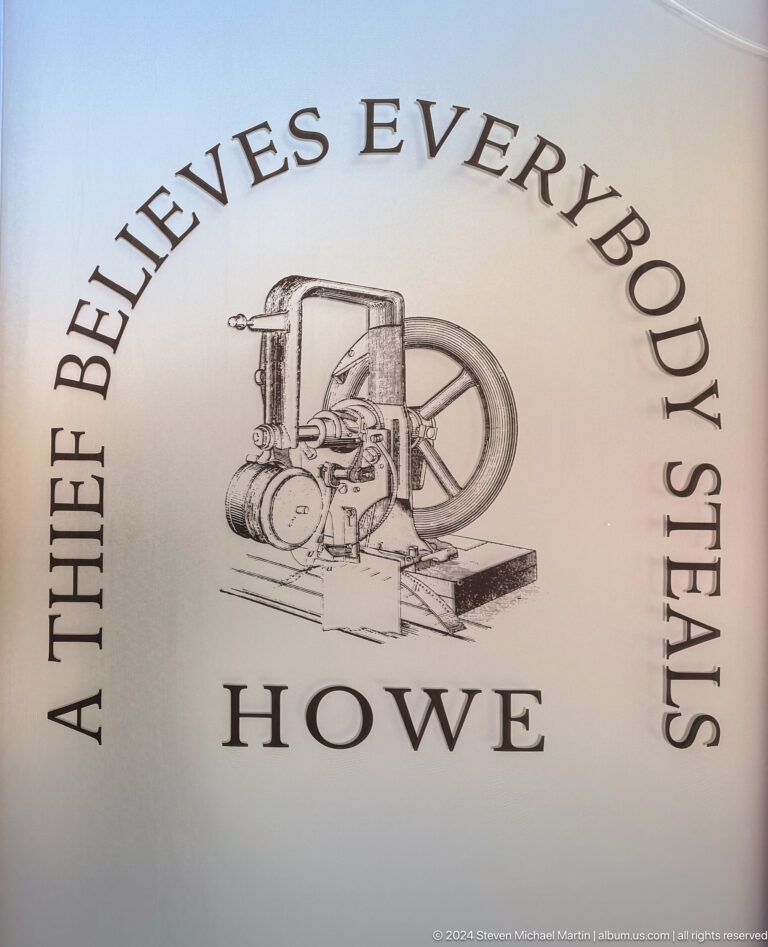 Interpretive graphic in Almaty showing an early industrial machine in an industrial-history illustration.