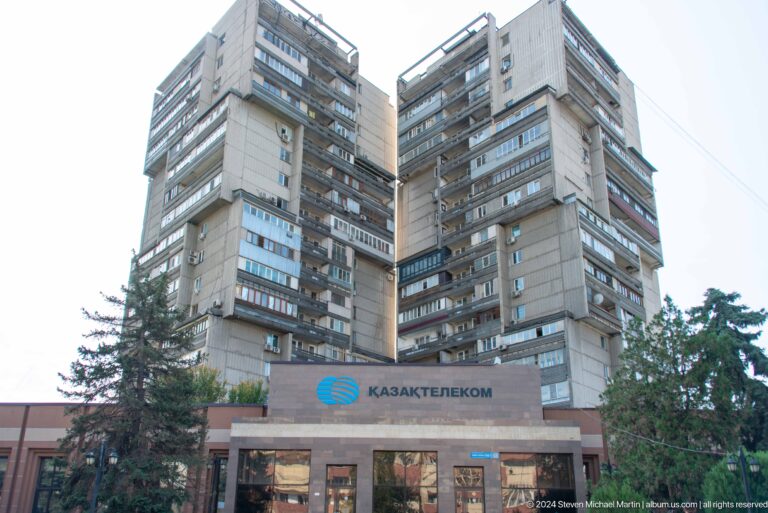 Tall Soviet-era Kazakhstan Hotel building dominating the urban skyline in Almaty.