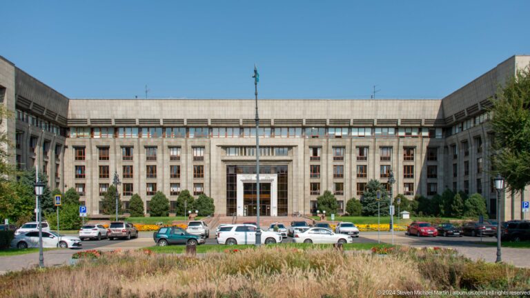 Large government or administrative building across a wide avenue in Almaty, Kazakhstan.