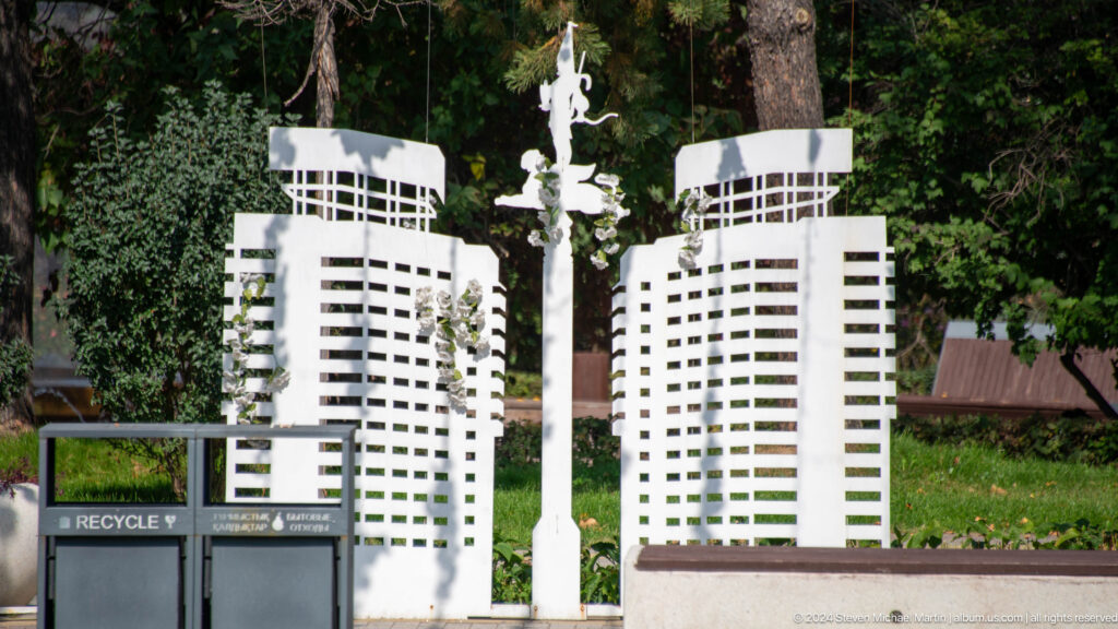 White architectural scale models of twin modern towers and a central monument representing Almaty landmarks.