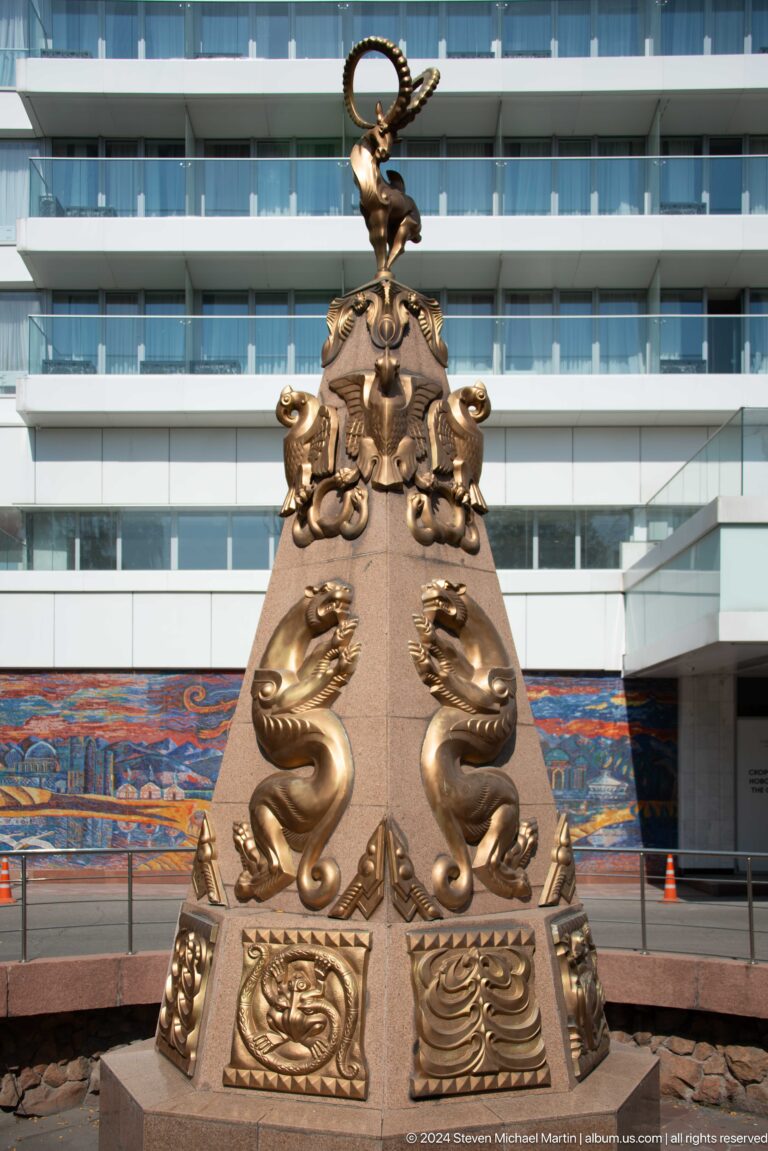 Close view of a Kazakh-style bronze ornament with animal motifs, part of decorative sculpture in Almaty, Kazakhstan.