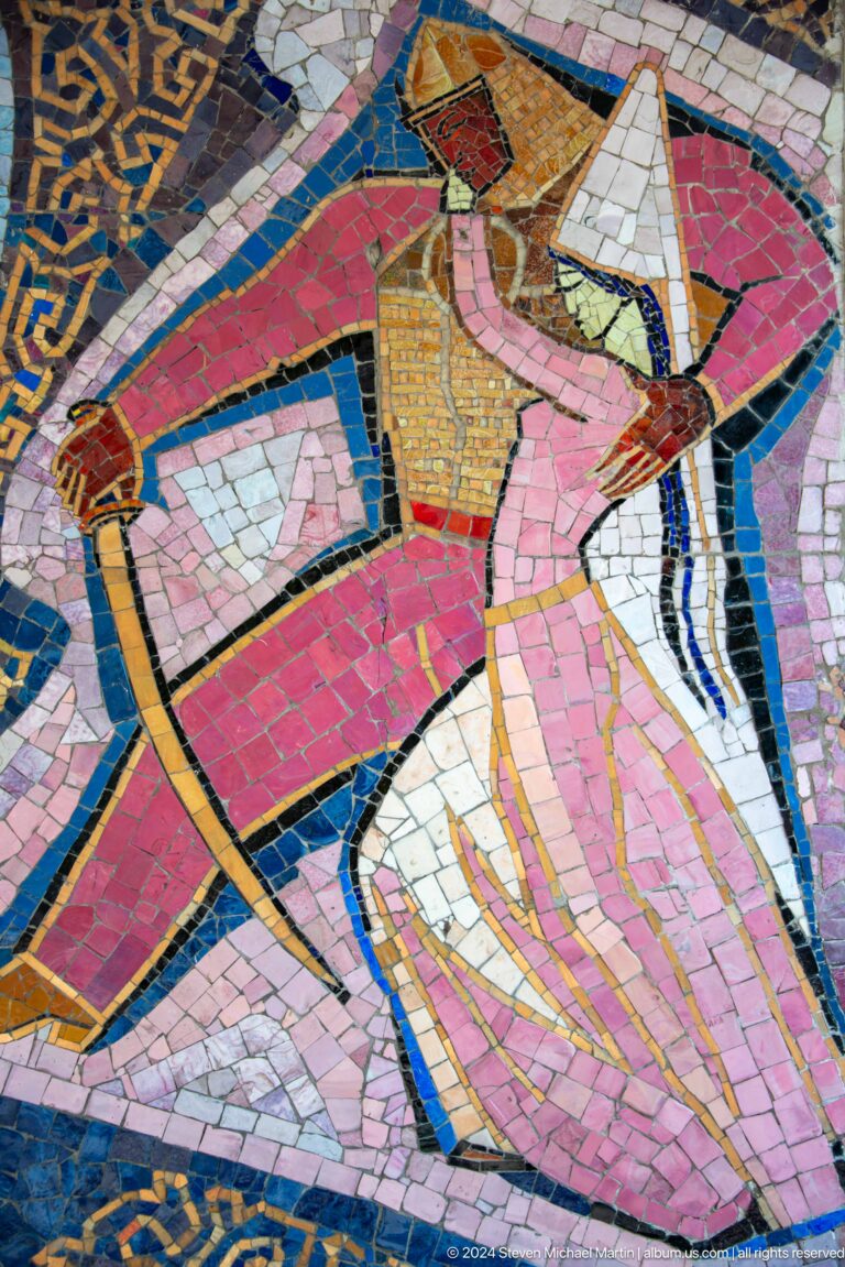 Close-up of a mosaic showing a Central Asian woman in pink robes, rendered in colored tesserae as part of a public artwork in Almaty, Kazakhstan.