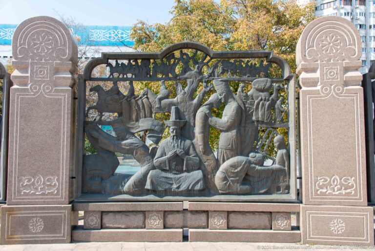 Ornate Kazakh-style metal fence panel featuring an animal and stylized foliage.