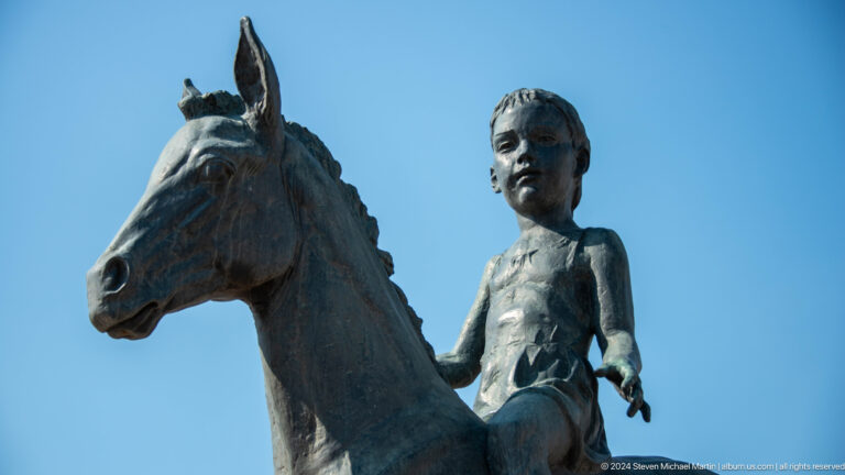Bronze sculpture of a child with a horse in a public space in Almaty, Kazakhstan.