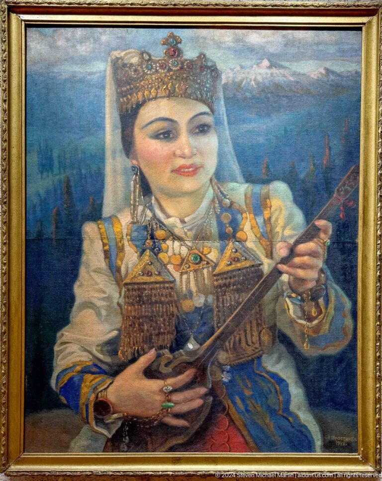 Framed painting of a woman holding a stringed instrument displayed on a museum wall.