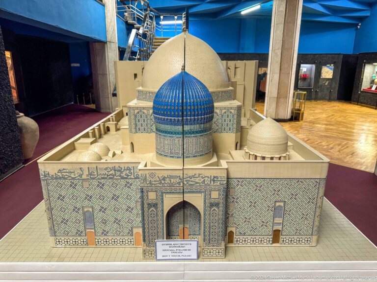 Medium view of an architectural scale model with a large blue dome and portal, displayed in the Central State Museum in Almaty, Kazakhstan.