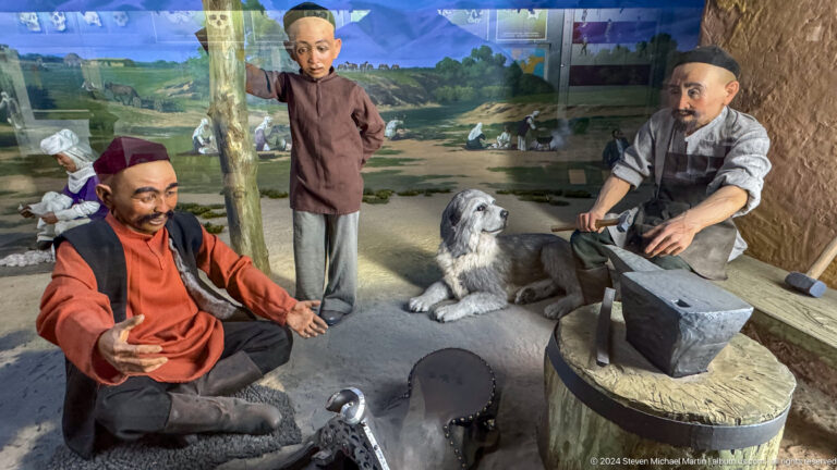 Life-size ethnographic diorama of seated craftspeople working inside a traditional dwelling at the Central State Museum of Kazakhstan in Almaty.