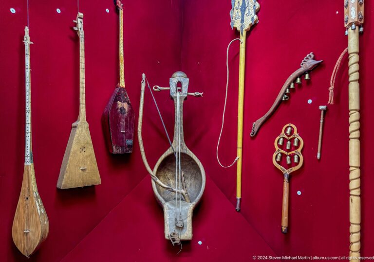 Wall display of traditional Kazakh string, bow, and wind instruments at the Central State Museum in Almaty, Kazakhstan.