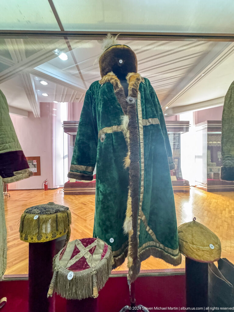 Green fur-trimmed velvet coat on a mannequin in the Central State Museum of Kazakhstan in Almaty.
