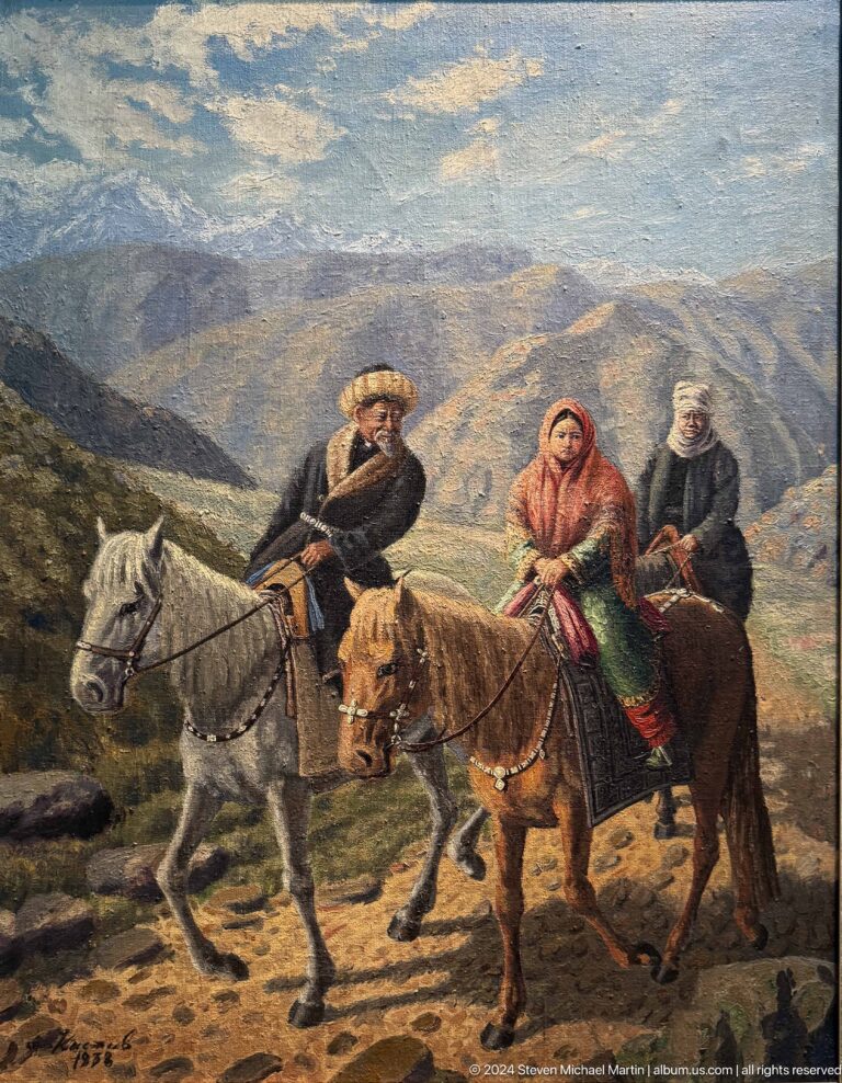 Three mounted travelers before mountains.