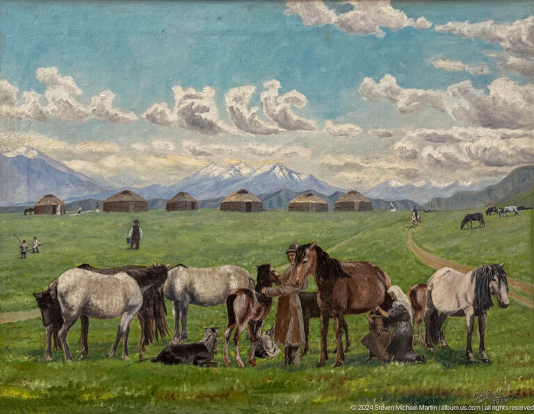 Horses grazing on broad mountain pasture.