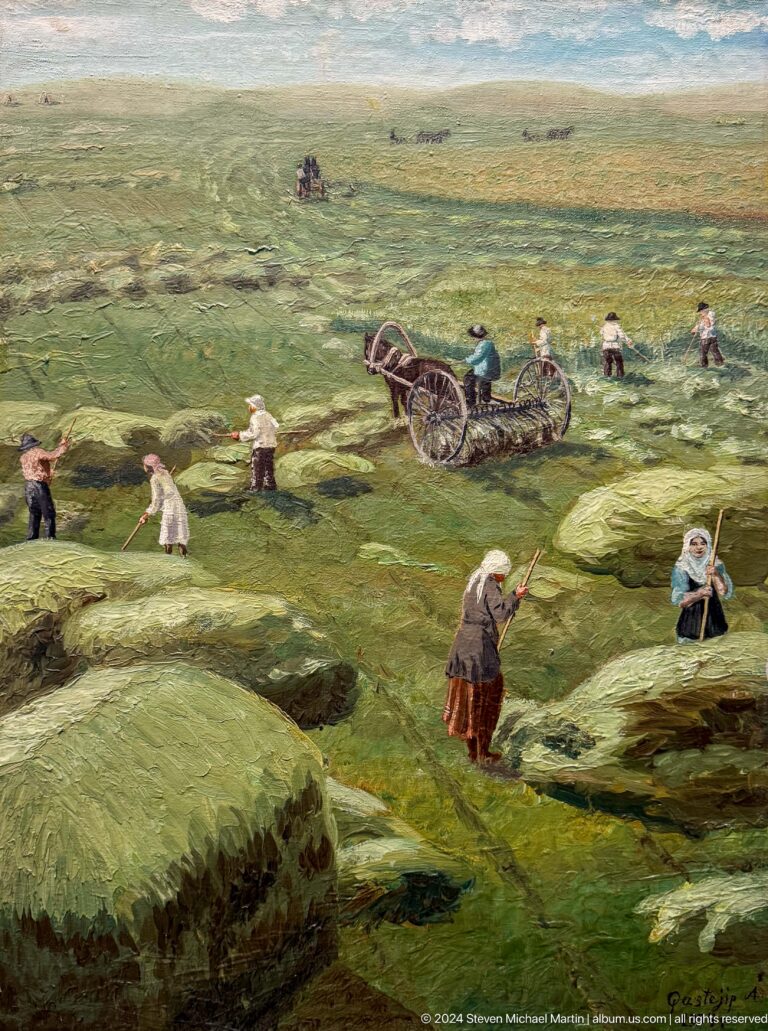 People working in green pasture beside cart.