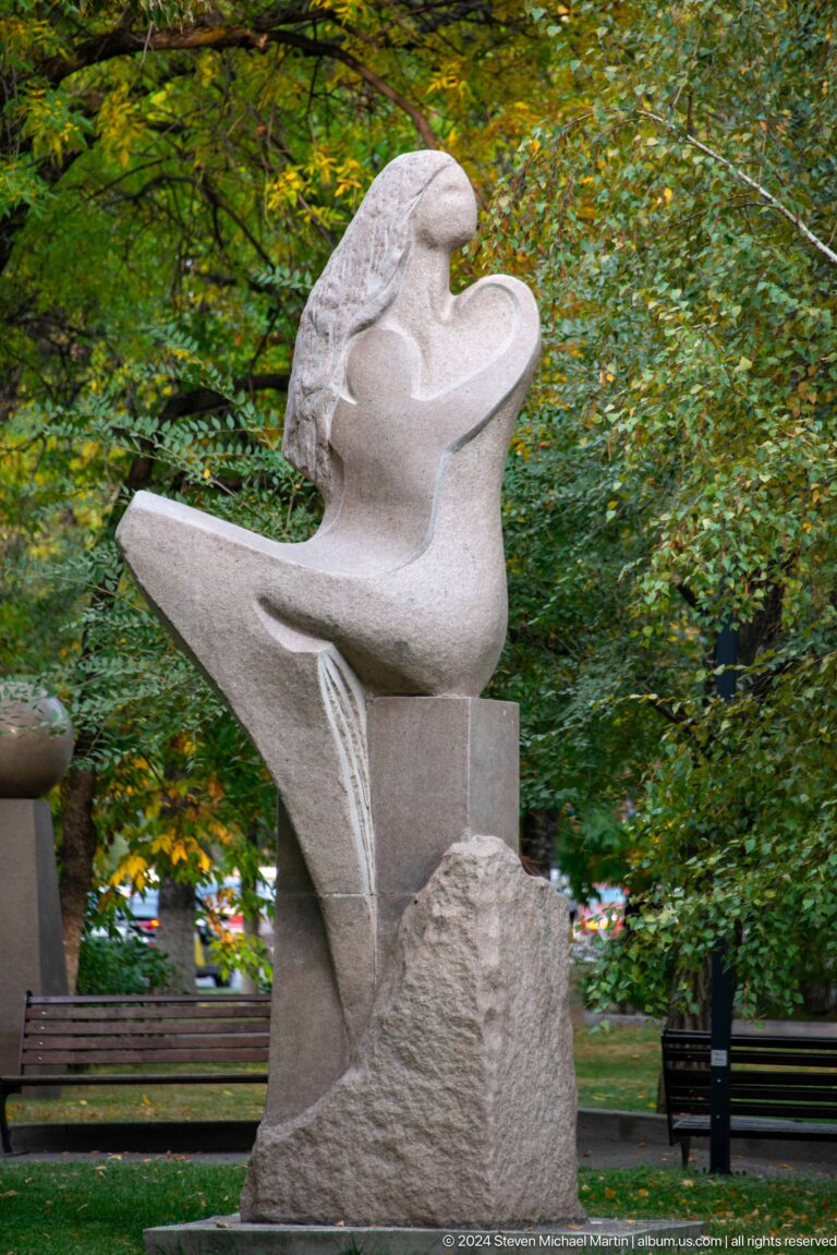 Abstract pale stone torso outdoors.