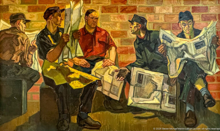 Men reading newspapers in a busy room.