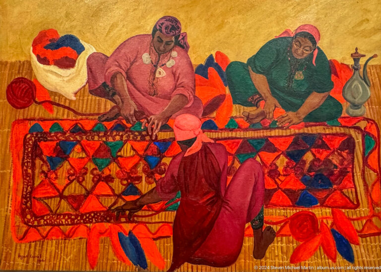 Women making a patterned carpet or textile.