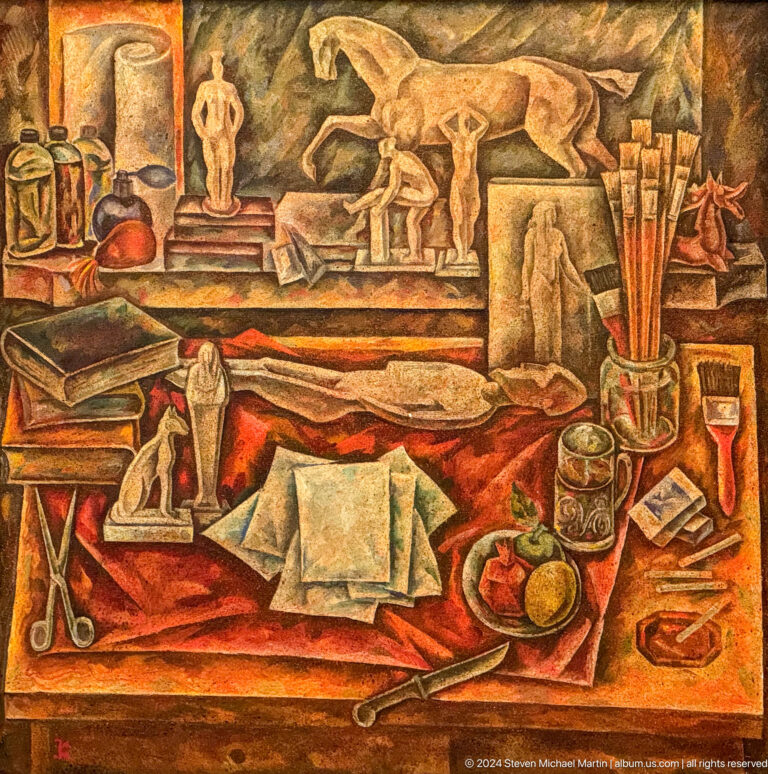 Studio still life with papers tools and small sculptures.