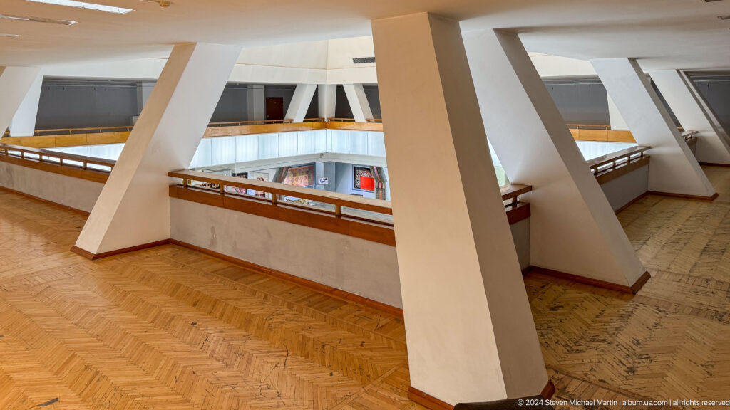 Museum balcony with angled white structural supports.