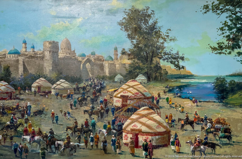 Crowded riverside market with yurts and fortified city.