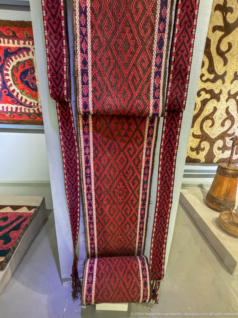 Two narrow red patterned textile bands.