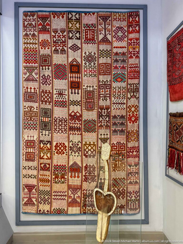 Wall of narrow geometric woven bands.