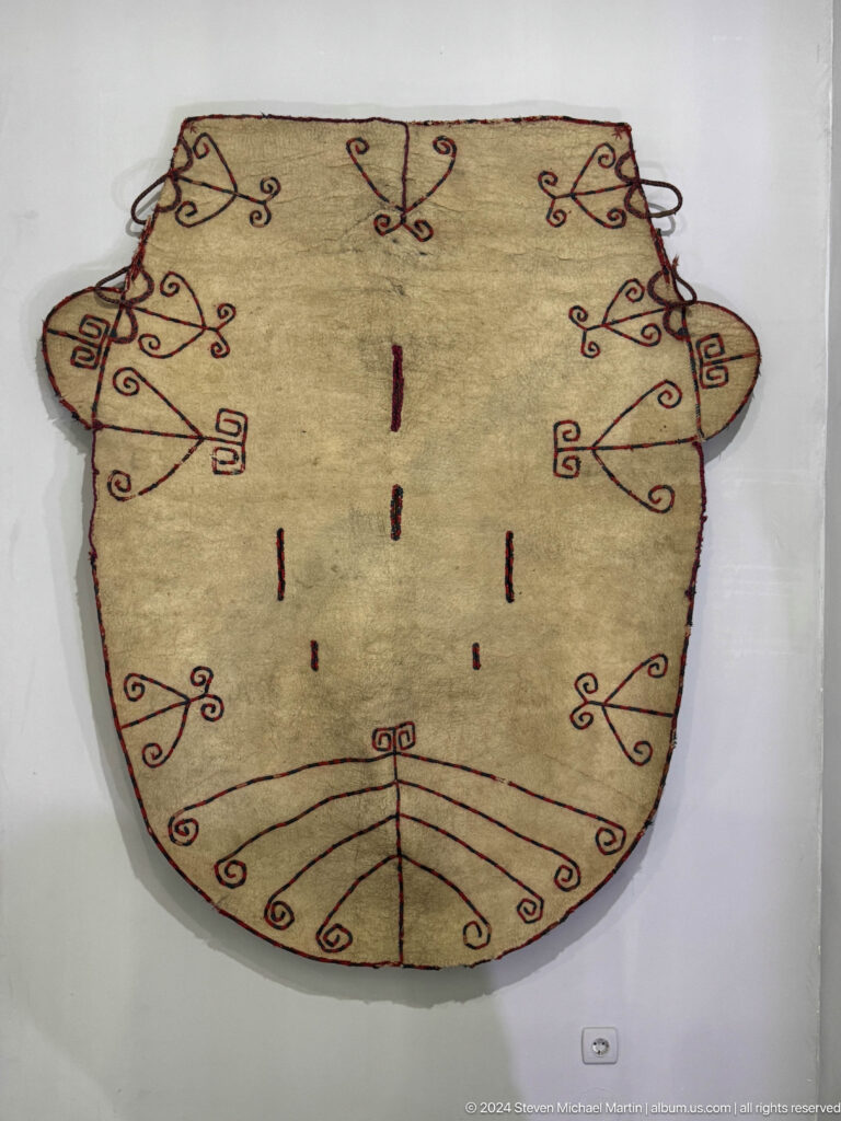 Cream felt panel with sparse dark line motifs.