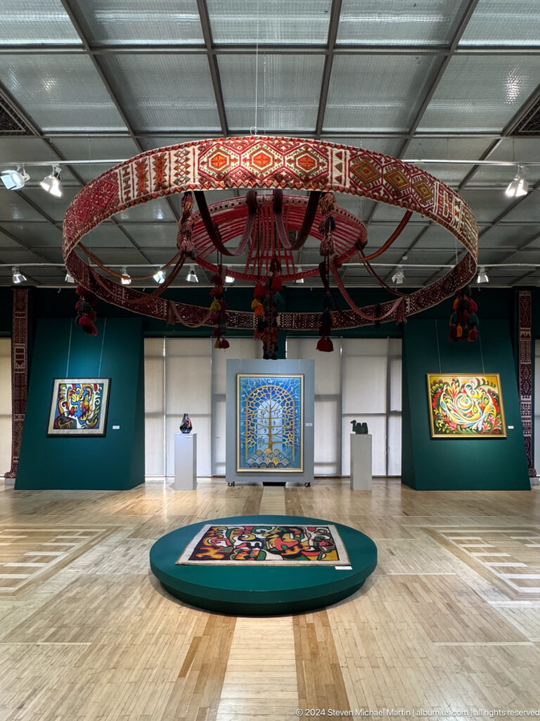 Gallery installation with circular hanging canopy.