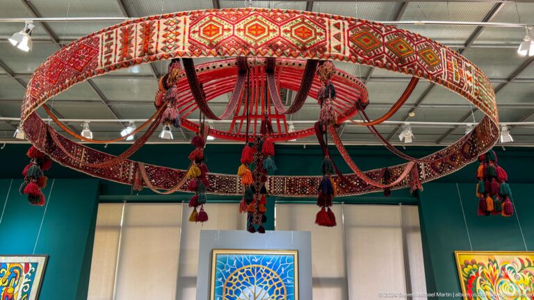 Close view of decorated circular canopy and tassels.