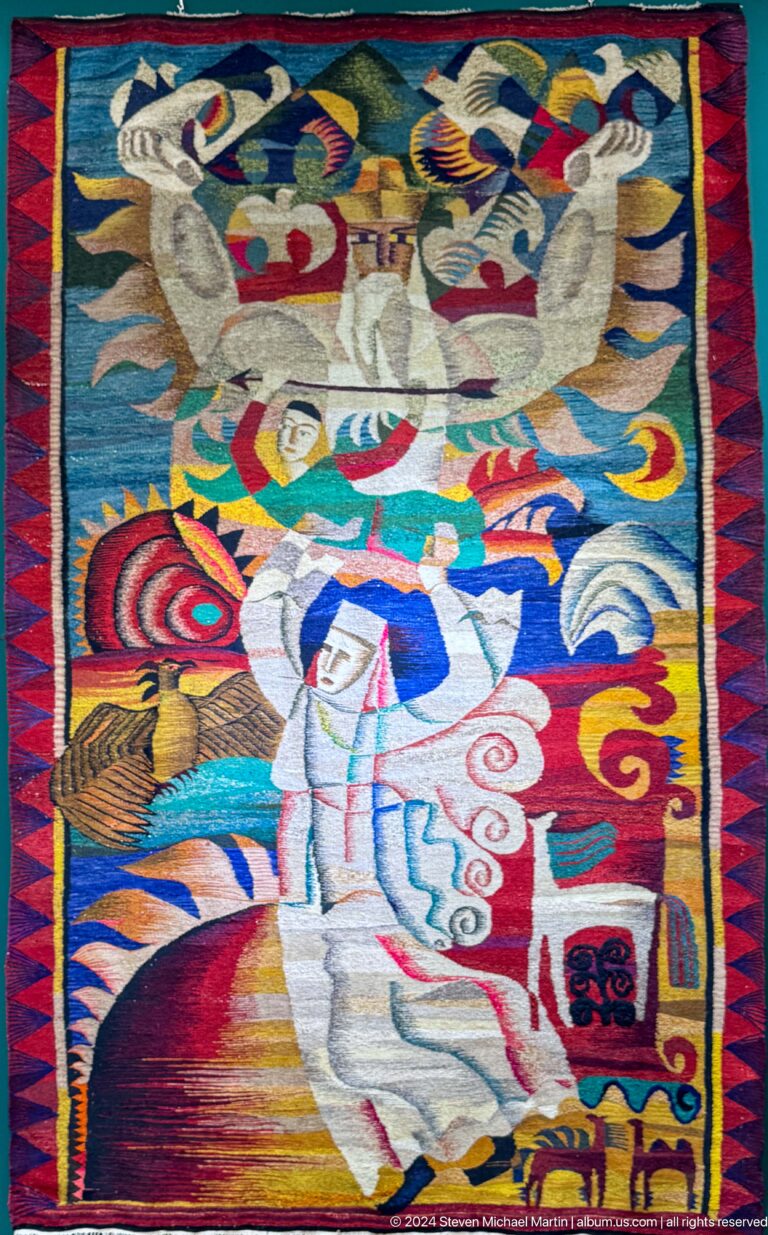 Bright textile with stylized human and animal forms.