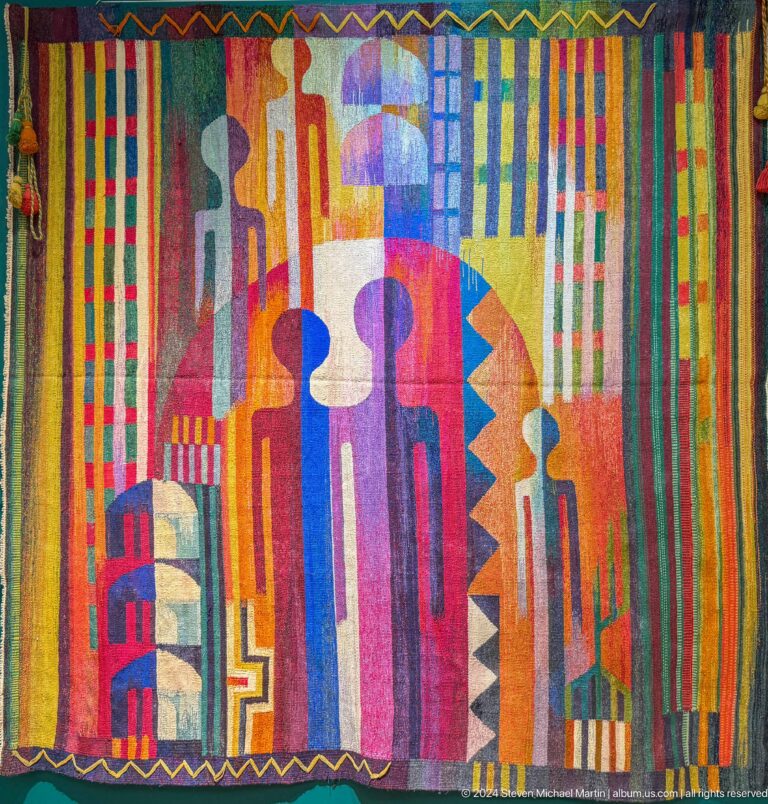 Geometric textile with vertical stripes and figures.