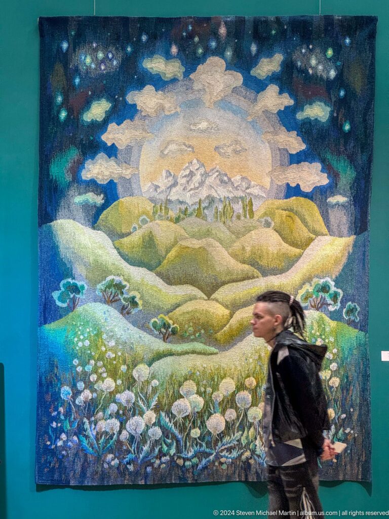 Large textile mountain landscape with visitor crossing.