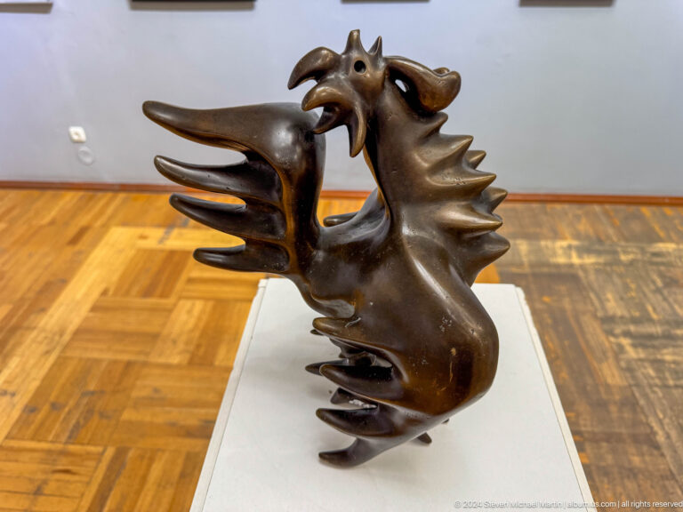 Two interlocking stylized animal heads.