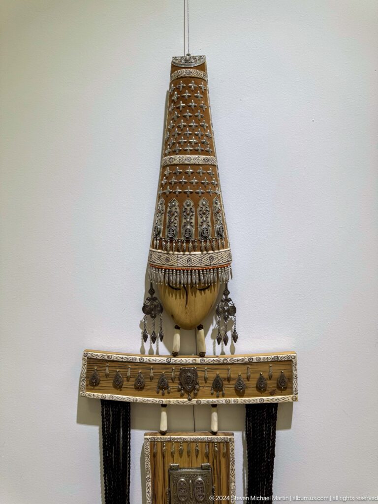 Ornate hanging string instrument.