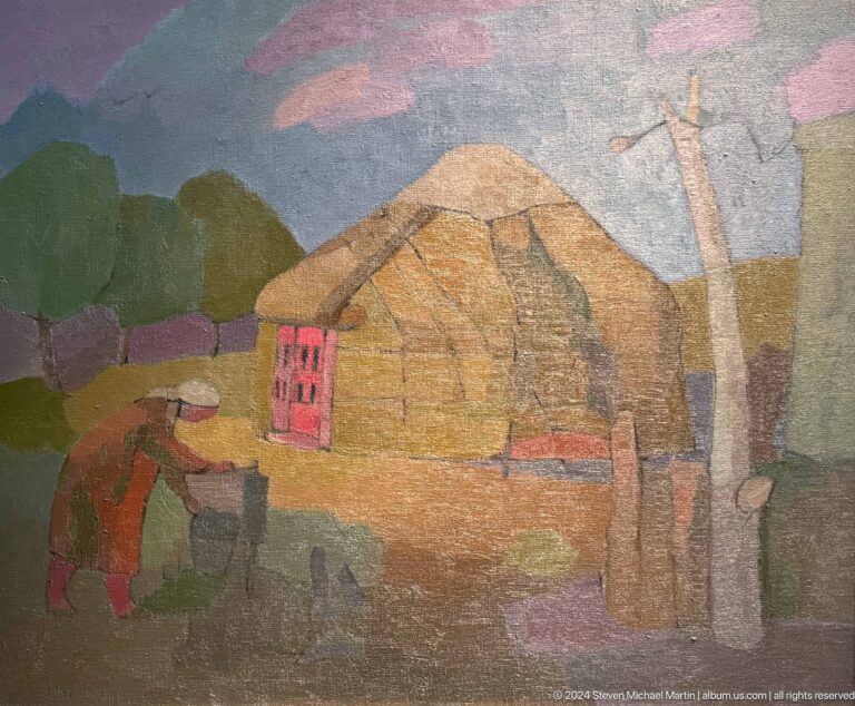 Rural house and haystack in muted landscape.