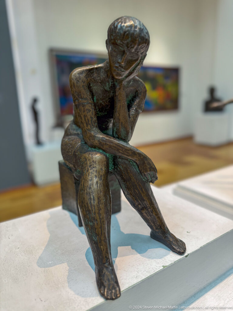 Seated contemplative figure close view.