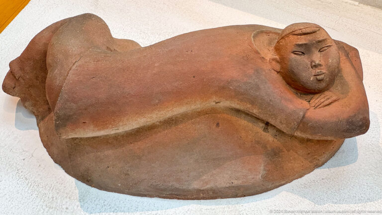 Reclining terracotta human figure.