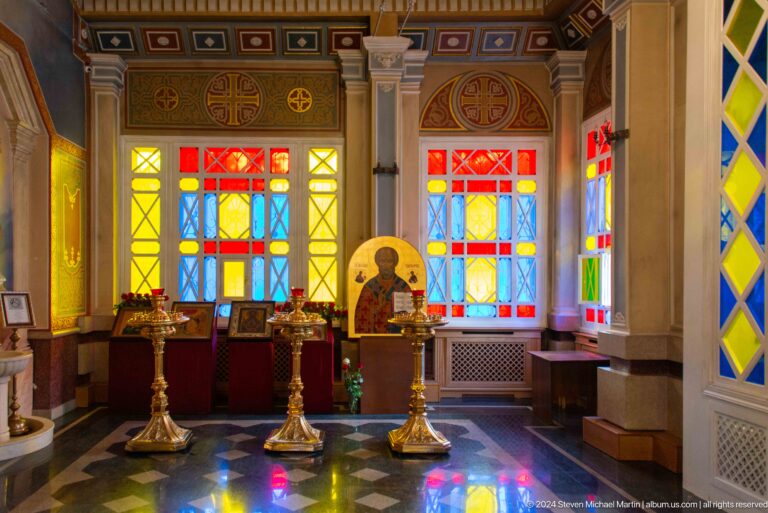 Interior side chapel with stained glass inside Zenkov Cathedral, with Orthodox religious decoration.