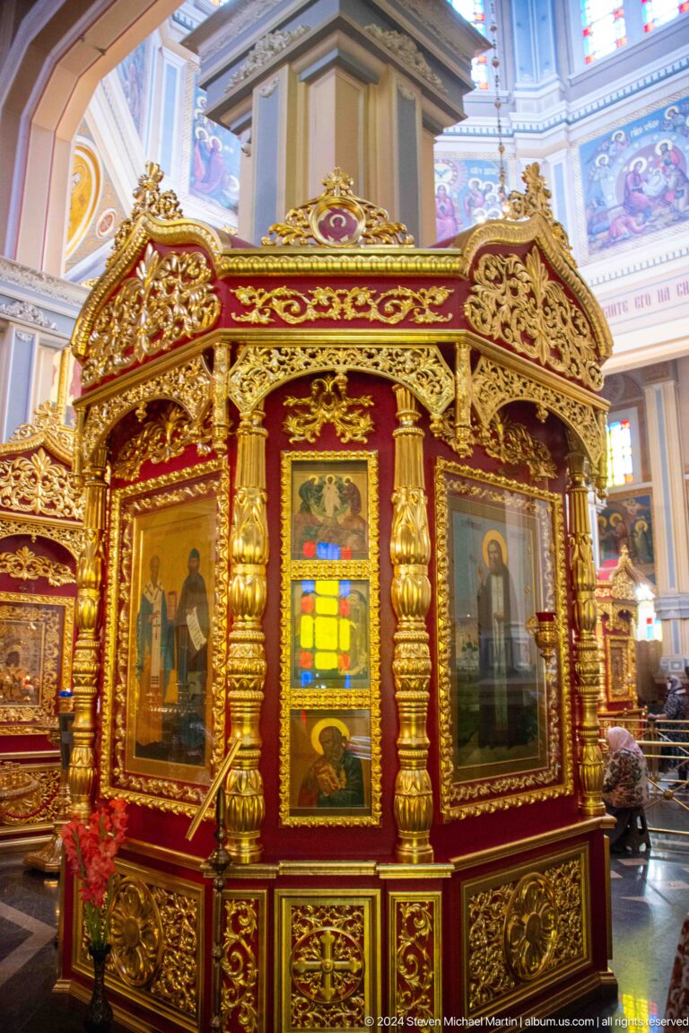 Gilded icon case with central icon inside Zenkov Cathedral, with Orthodox religious decoration.