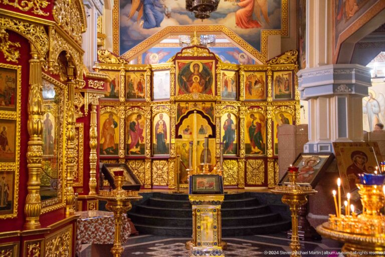 Iconostasis viewed from nave inside Zenkov Cathedral, with Orthodox religious decoration.