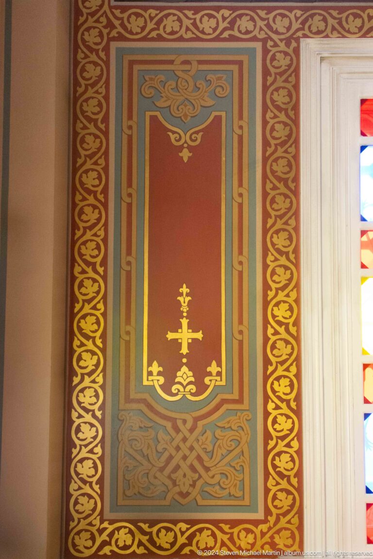 Painted wall panel with Orthodox cross inside Zenkov Cathedral, with Orthodox religious decoration.