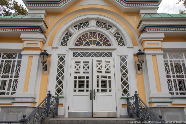 Daylight exterior entrance doors at the colorful wooden Zenkov Cathedral in Almaty.