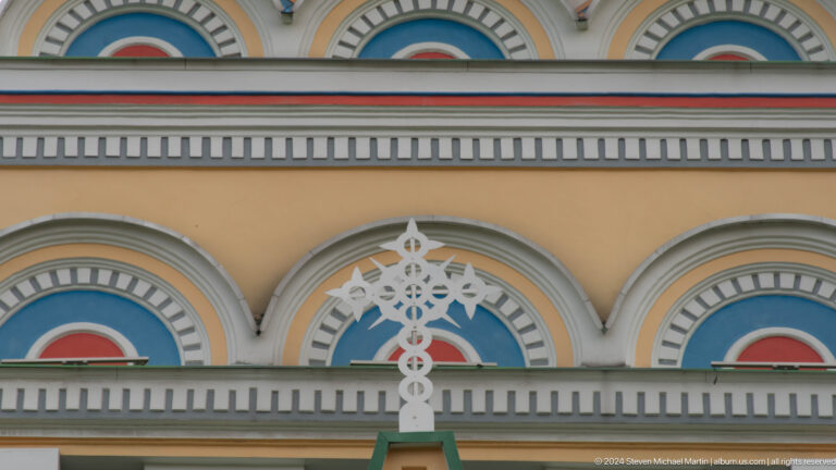 Painted exterior arch and wood ornament at the colorful wooden Zenkov Cathedral in Almaty.